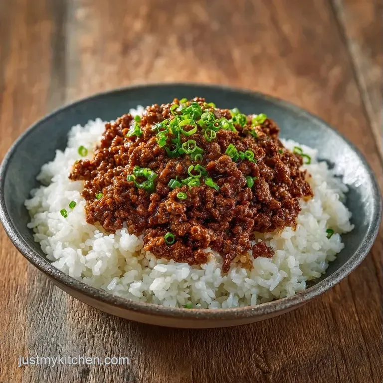 Elegant white ceramic bowl featuring seared beef over fluffy rice, topped with sliced scallions and sesame seeds.