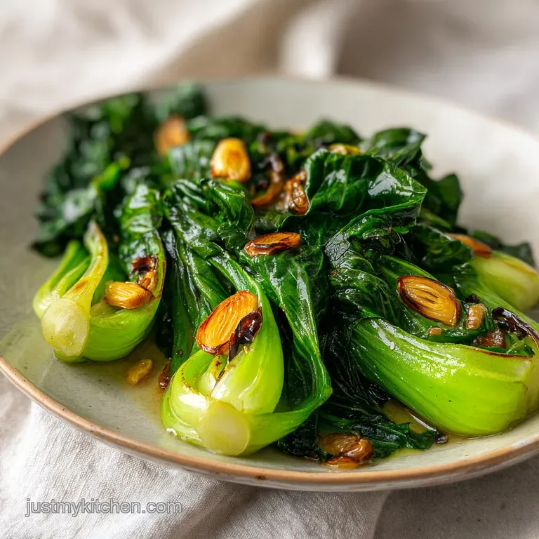 Tender green stalks and white stems arranged on a white platter, drizzled with a rich, glossy savory brown glaze.