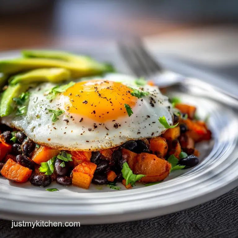 Bright breakfast plate featuring pan-fried sweet potato hash, black beans, vibrant green avocado slices, topped with a run...