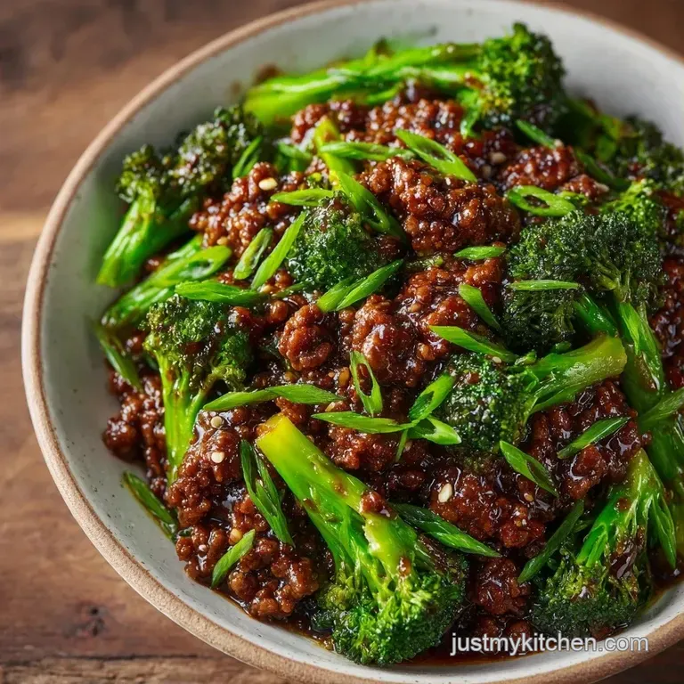A modern ceramic bowl of savory brown beef crumbles over steaming rice, topped with a sprinkle of toasted sesame seeds.