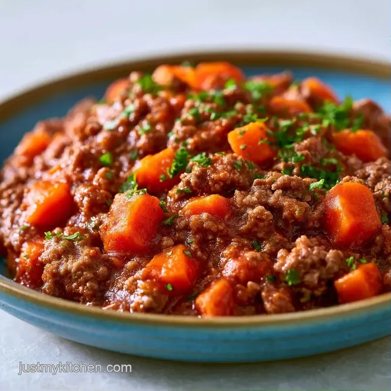 A square slice of cheesy beef bake served on a white ceramic plate, garnished with fresh chopped parsley sprigs.